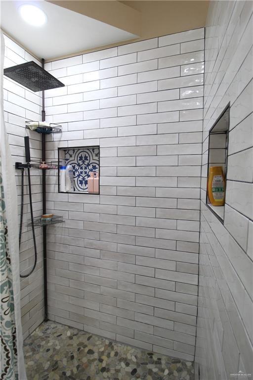 bathroom with tiled shower