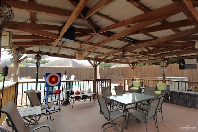 view of patio featuring outdoor dining area, fence, and a gazebo