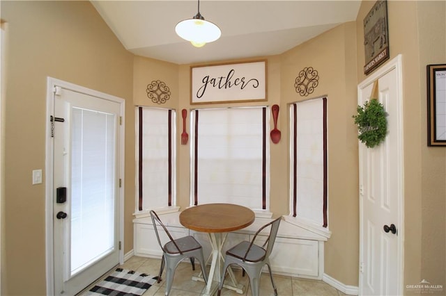 dining space with light tile patterned floors and baseboards