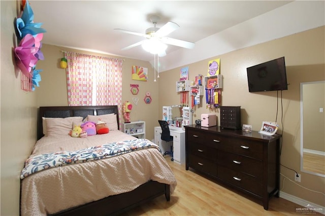 bedroom featuring ceiling fan, light wood-type flooring, and baseboards