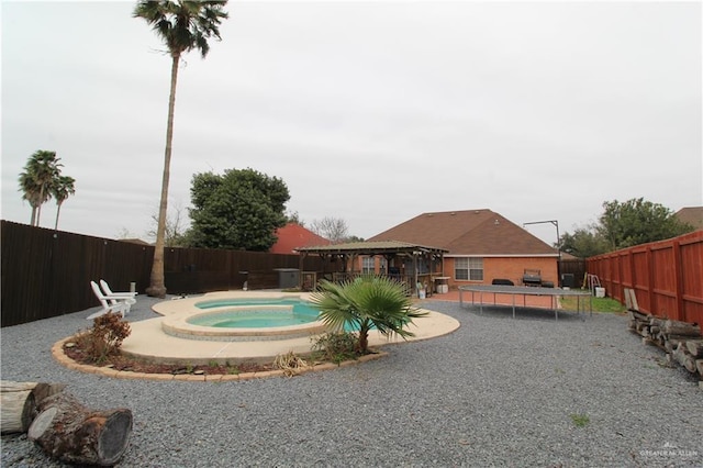 view of swimming pool with a gazebo, a patio, a fenced backyard, and an in ground hot tub