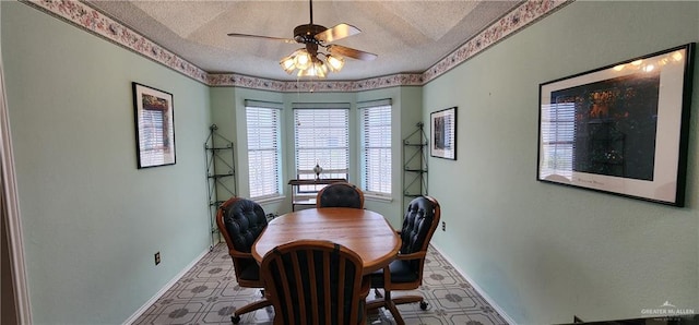 dining space with ceiling fan and a textured ceiling