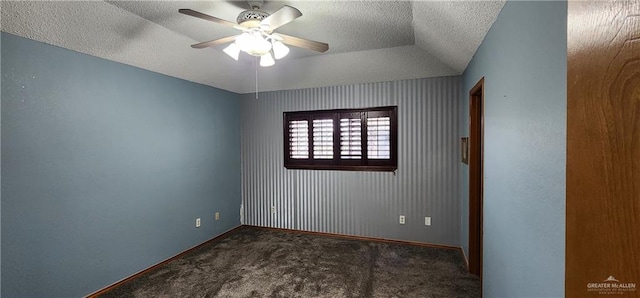 carpeted spare room with a textured ceiling, ceiling fan, and lofted ceiling