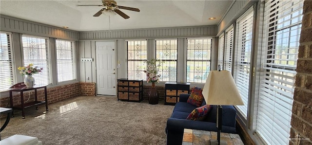 sunroom featuring ceiling fan