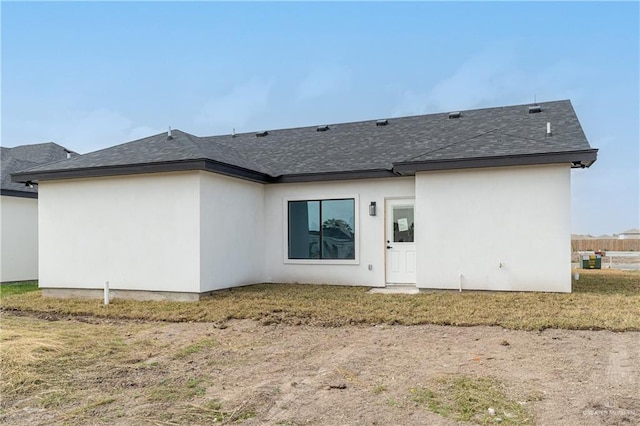 rear view of house featuring a yard