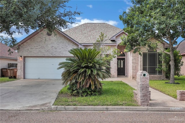 3313 Roadrunner Dr, Edinburg, TX 78541 - view of front facade featuring concrete driveway, an attached garage, brick siding, and a front lawn
