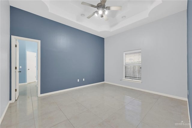 3313 Roadrunner Dr, Edinburg, TX 78541 - spare room with a tray ceiling, a ceiling fan, and tile patterned floors