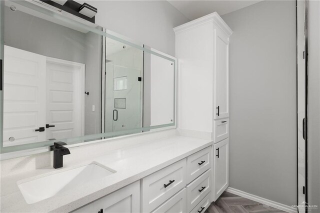 bathroom with vanity, parquet floors, and walk in shower