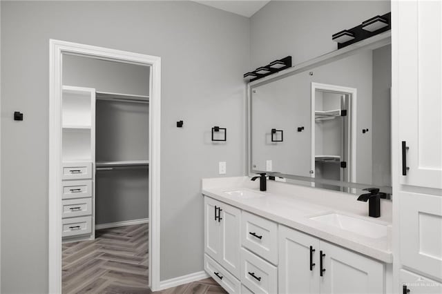 bathroom featuring vanity and parquet flooring