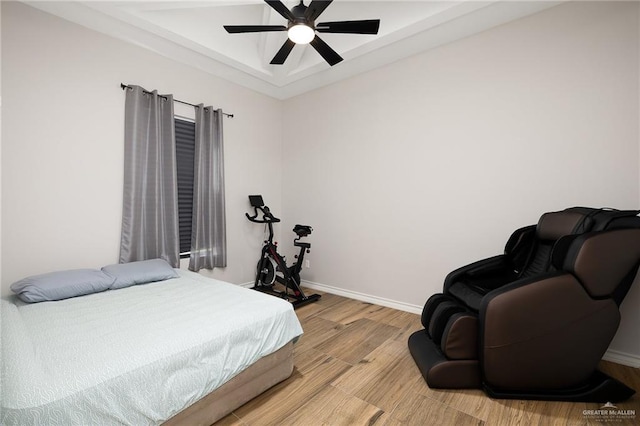 13811 N 33rd Ln, Mcallen, TX 78504 - bedroom featuring light wood finished floors, a tray ceiling, and ceiling fan