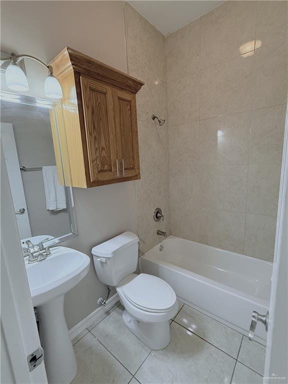 bathroom featuring shower / bathtub combination, a sink, toilet, and tile patterned floors