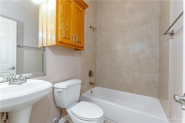 bathroom with  shower combination, a sink, and toilet