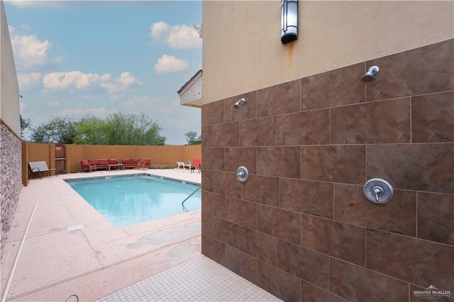 view of pool with a fenced in pool, a patio, and fence