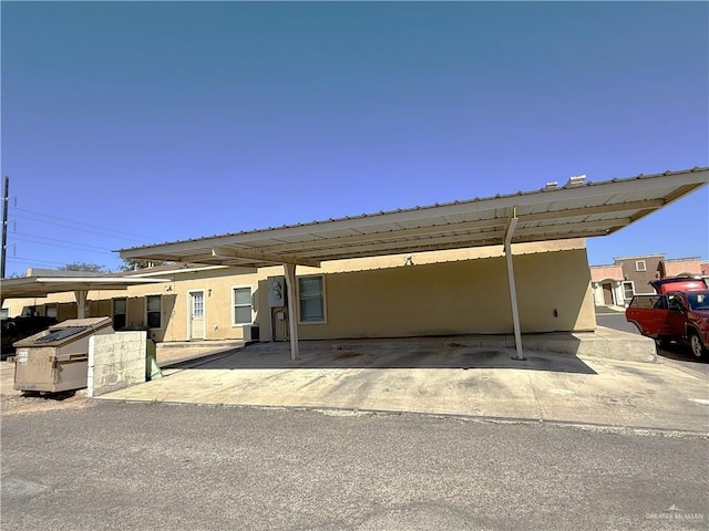 view of front of property featuring a carport and stucco siding