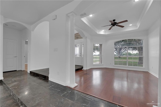 interior space featuring crown molding, a tray ceiling, and ceiling fan