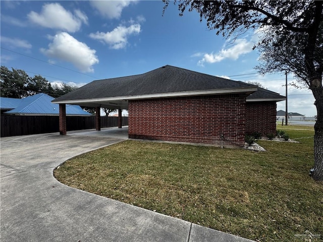 view of side of property with a lawn and a carport