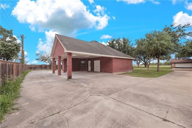 view of home's exterior with a carport and a lawn