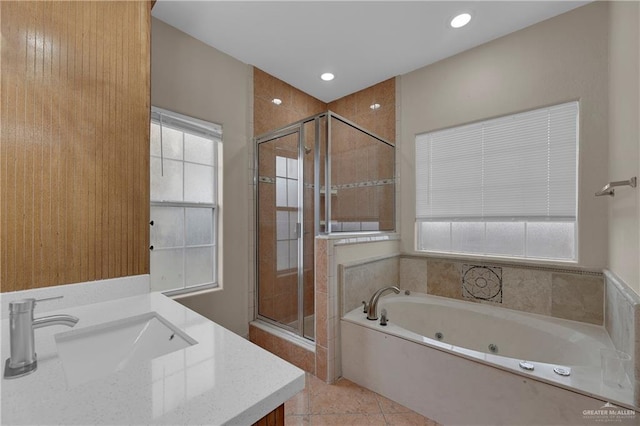 bathroom featuring vanity, tile patterned flooring, independent shower and bath, and a healthy amount of sunlight