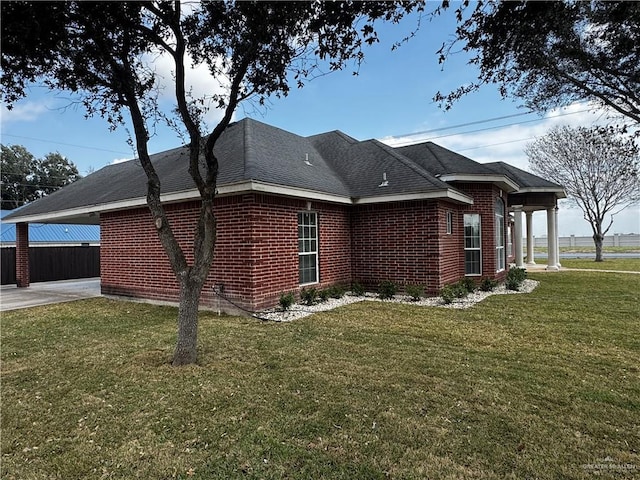 view of property exterior featuring a yard and a carport