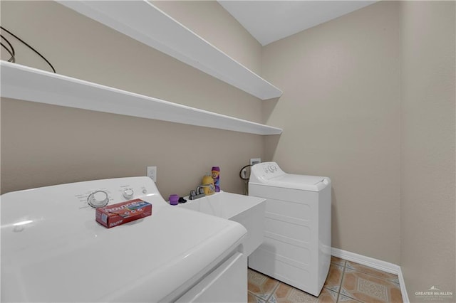 laundry area featuring light tile patterned floors and washer and dryer