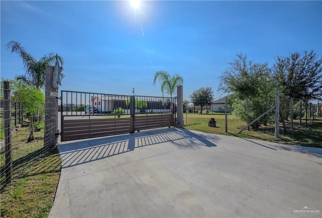 view of gate with a yard