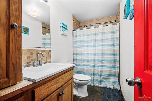 bathroom featuring a shower with shower curtain, tasteful backsplash, vanity, wood-type flooring, and toilet