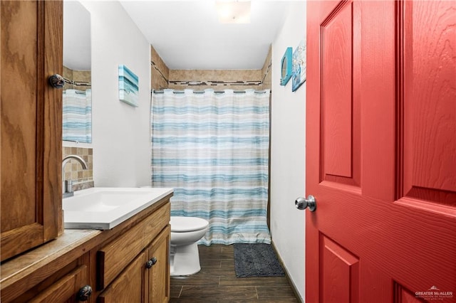 bathroom featuring vanity, wood-type flooring, and toilet