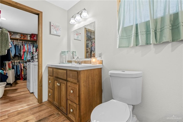 bathroom featuring hardwood / wood-style floors, vanity, and toilet