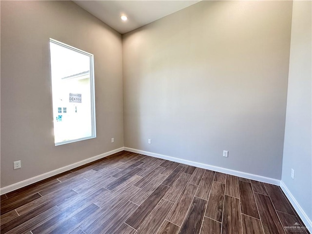 empty room with dark wood-type flooring