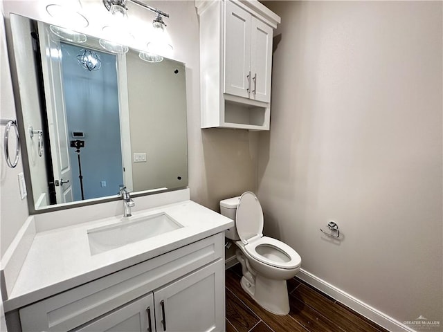 bathroom featuring hardwood / wood-style flooring, vanity, and toilet