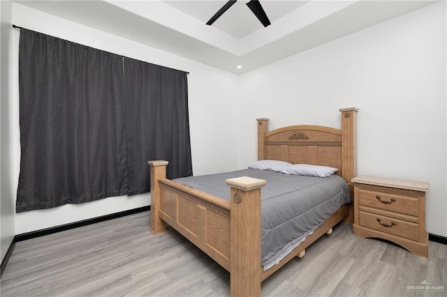 1820 Hill Dr, Mission, TX 78572 - bedroom featuring light wood finished floors, a tray ceiling, a ceiling fan, and recessed lighting