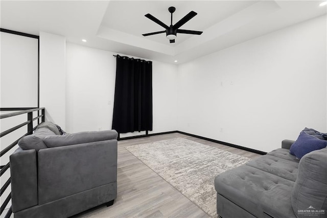 1820 Hill Dr, Mission, TX 78572 - living room with ceiling fan, a raised ceiling, light wood finished floors, recessed lighting, and baseboards
