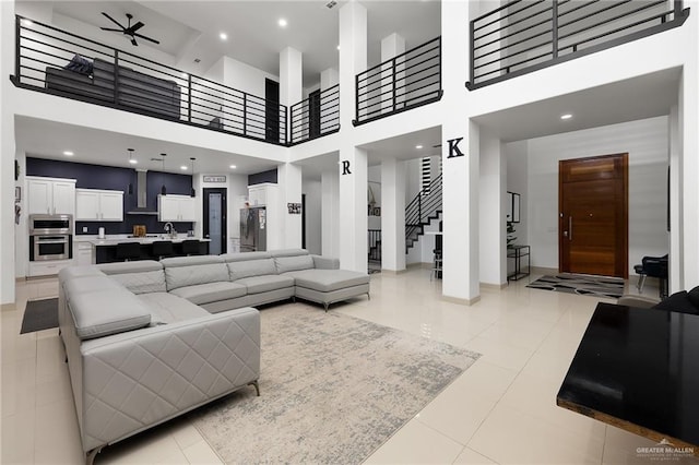 1820 Hill Dr, Mission, TX 78572 - living room featuring a towering ceiling, light tile patterned floors, stairs, and ceiling fan