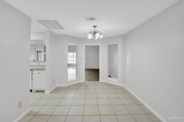 704 Kerry Ln, Mcallen, TX 78504 - unfurnished dining area with a chandelier, baseboards, and light tile patterned floors