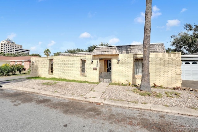 704 Kerry Ln, Mcallen, TX 78504 - view of front of house featuring brick siding and mansard roof