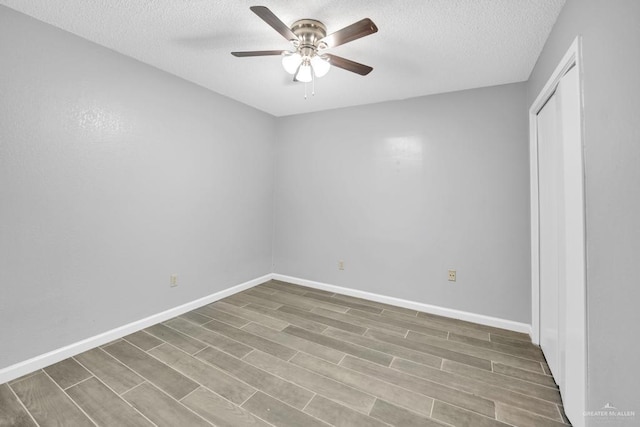 704 Kerry Ln, Mcallen, TX 78504 - empty room with ceiling fan, a textured ceiling, wood finished floors, and baseboards