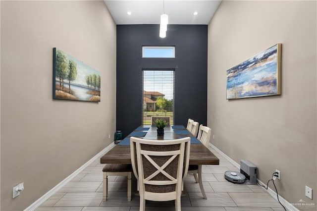 201 White Oak Dr, Los Fresnos, TX 78566 - dining area with baseboards and a towering ceiling