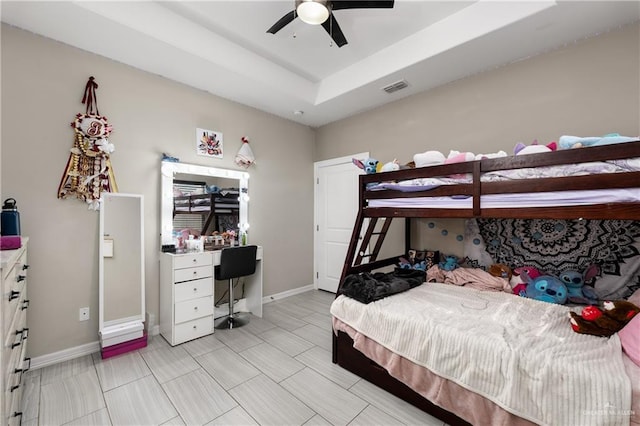 201 White Oak Dr, Los Fresnos, TX 78566 - bedroom with an office area, a ceiling fan, and a raised ceiling
