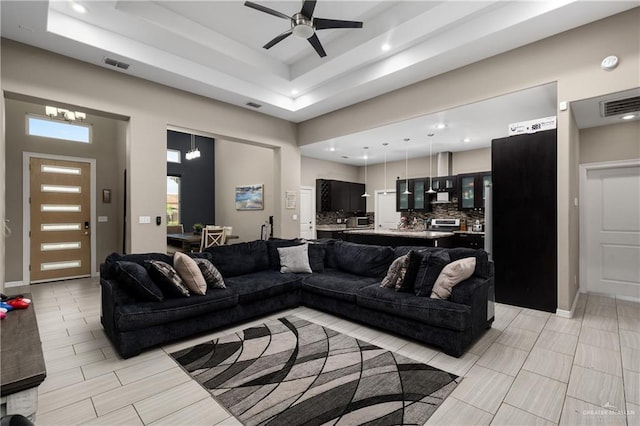 201 White Oak Dr, Los Fresnos, TX 78566 - living area with a ceiling fan, recessed lighting, a raised ceiling, a chandelier, and a towering ceiling