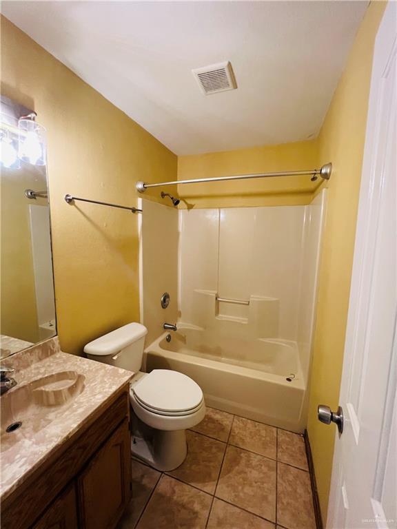 8200 Tierra Linda Ln, Mission, TX 78574 - full bathroom with vanity, washtub / shower combination, and tile patterned flooring