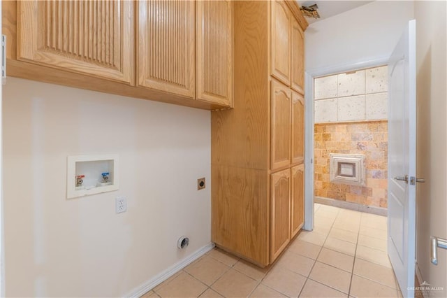 laundry room with washer hookup, cabinet space, electric dryer hookup, and light tile patterned floors