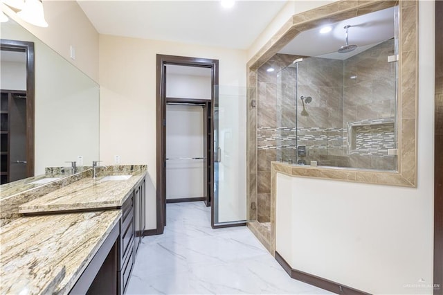 bathroom with vanity and a shower with shower door