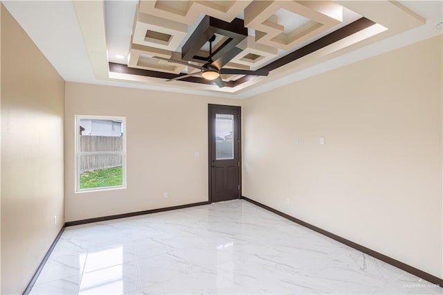 spare room with coffered ceiling, ceiling fan, and a tray ceiling