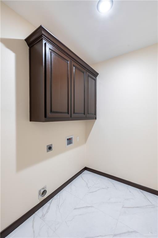 3812 Santa Fe St, Edinburg, TX 78542 - washroom featuring electric dryer hookup, light marble finish flooring, baseboards, and cabinet space
