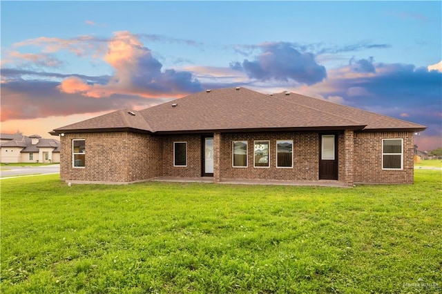 3812 Santa Fe St, Edinburg, TX 78542 - rear view of property with roof with shingles, a patio, a yard, and brick siding