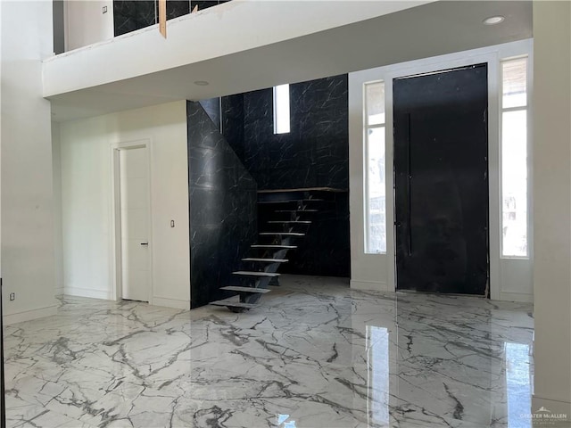 entryway with plenty of natural light and tile walls