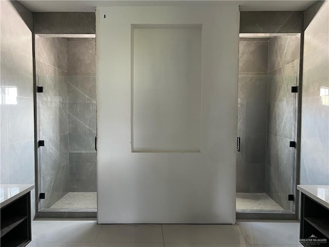 bathroom with tile patterned flooring, vanity, and a shower with shower door