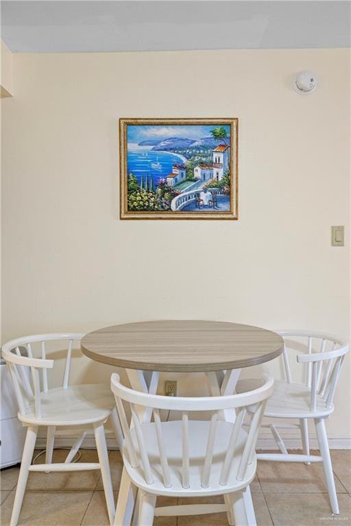 dining area with baseboards and light tile patterned floors