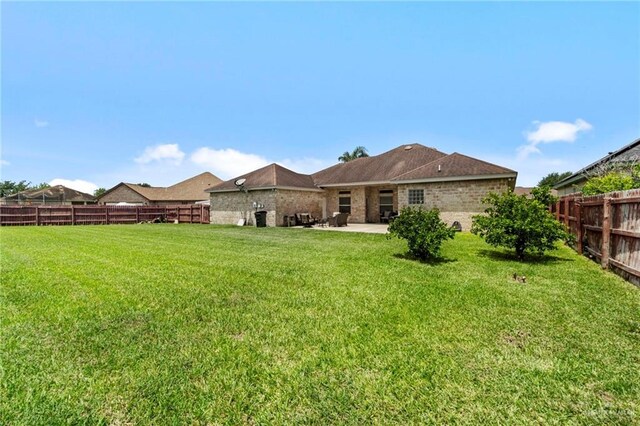 back of property featuring a patio and a lawn