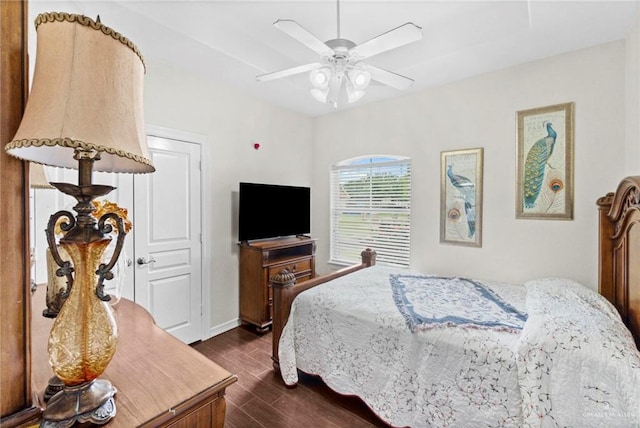 bedroom with dark hardwood / wood-style floors and ceiling fan